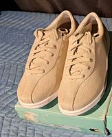 Front and top view of both sneakers showing canvas material and lace-up design