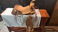 Left side view of full saddle on stand