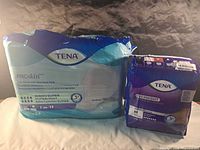 Front view of both sealed TENA packages