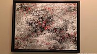 Full view of framed abstract painting on wall