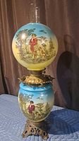 Full view front showing painted hunter scene, both globes, metal base, chimney