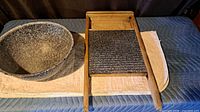 Washboard and graniteware bowl side by side on cloth