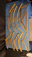 Top-down view of all wooden hangers arranged on blanket
