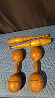 Full set of two Indian clubs and two dumbbells on quilted pad