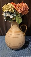 Pitcher vase front view with flowers for scale