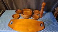 Full set of tray, bowls, pepper mill on padded surface