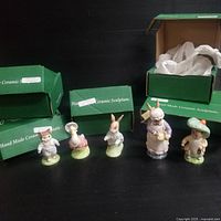 Five Beswick vintage ceramic figurines in front of their green boxes
