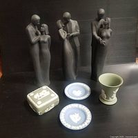 Photo showing three Doulton gray matte porcelain figurines of couples along with Wedgwood blue jasperware plates, green jasperware vase, and square box