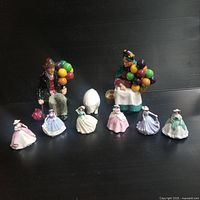 Overview of all nine porcelain figurines arranged on black background