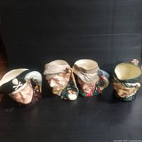 Front view of all four extra large vintage Toby jugs showing the various character faces and features.