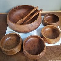 Photo showing the whole set - large salad bowl, four smaller bowls, and salad servers.