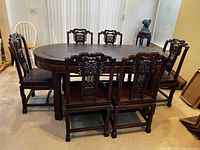 Full view of oval table and six chairs in room setting