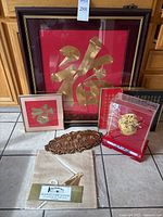 Wide view of all items together showing frame embroidery, plaque, table runner, and display case medallion