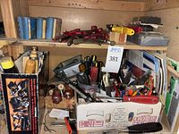 Shelf with various hand tools, screwdrivers, clamps, and containers filled with diverse tools.