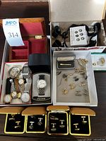 Overview of multiple wristwatches, jewelry box and cufflink presentation boxes