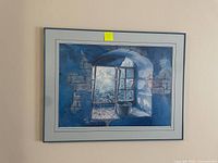 Framed signed art print 'Broken Window' by Ray Spier hanging on a wall, showing the window scene with blue color tones.