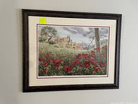 Framed art print showing red poppies in the foreground, rural buildings and trees in the background, under a cloudy sky. Print measures 37 x 29 inches as per seller.