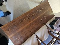 Top view of rectangular solid pine coffee table showing surface wear and wood grain pattern.