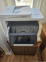 Front angle showing the full printer with control panel and feeder.