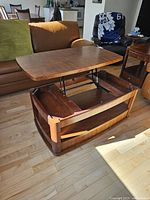 Lift-top surface raised showing internal storage compartment and lift mechanism.