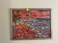 Full view of framed palette knife acrylic seascape painting showing rocky shoreline and turbulent sea