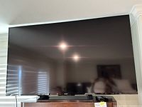 Front view of Sony 70-inch TV powered off, mounted on stand
