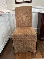 Front view of the Bombay Co. Parson chair showing patterned upholstery and full skirt.
