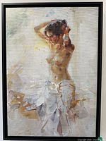 Front view of framed canvas print showing nude female model adjusting hair standing by window wrapped in white fabric.