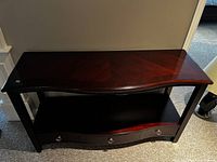 Front perspective of the console table showing top surface, middle shelf, and 3 drawers.