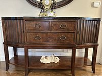 Front view of sideboard with marble top and lower shelf