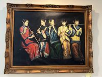 Front view of the painting showing five women in traditional Chinese dress playing wind instruments, set against a black background, framed in an ornate gold frame.