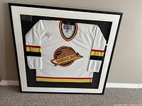 Front view of framed signed jersey showing full display