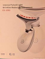 Photo of the box front showing the product name, model ES-1081, and an image of the handheld light therapy device emitting red light.