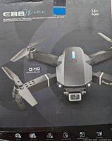 Photo of C88 E-zone drone in black packaging showing the drone with dual HD cameras and foldable arms, highlighting features like HD lens, dual camera, real-time map, long endurance, constant folding, app control.