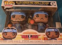 Front view of Funko Pop 2-pack box featuring Allen Iverson and Carmelo Anthony in NBA Jam style, showing the figures inside the window packaging.