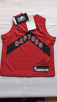 Front view of the kids Toronto Raptors basketball jersey size 2T with tags shown attached.