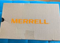 Closed cardboard box with Merrell branding printed in orange.
