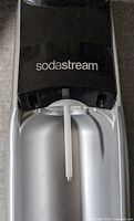 SodaStream machine focusing on upper portion with carbonation tube, showing clean and intact condition