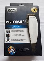 Front side of Wahl Performer MC hair clipper set box showing branding, claims, and key features like self-sharpening blades and taper control.