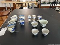 Overall view of all 12 porcelain pieces arranged on table