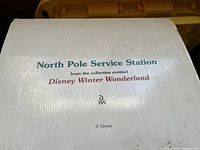 Photo of box top showing text: North Pole Service Station from the collection entitled Disney Winter Wonderland, © Disney trademark
