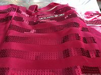 Pink Victoria's Secret tote bag with horizontal dark pink sequin stripes and 'Victoria's Secret' logo in white on front.