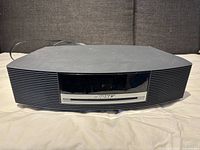 Front view showing black body with CD slot, speakers and Bose logo