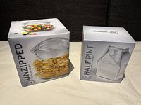 Two boxes showing images of the Frank glass bag bowl and half pint creamer in packaging