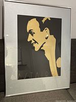 Framed lithograph showing a stylized gold profile image of Fred Astaire on a black background.