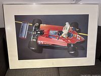 Full view of framed lithograph on couch