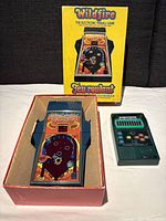 Wildfire electronic pinball game in original box along with Mattel Classic Football 2 handheld game