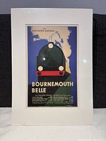 Framed vintage style Southern Railway Bournemouth Belle train poster replica in white matte frame, wrapped in original shrink wrap.