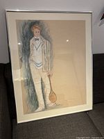 Full view of framed costume designer sketch depicting male in white and blue blazer with tennis racket