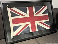 Front view of black wood frame and glass with Union Jack flag centered